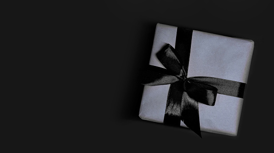 Gift box on black color, directly above.