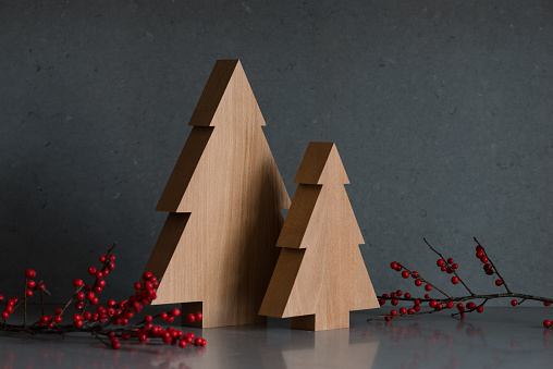 Wooden Christmas trees against a gray background. Modern concept