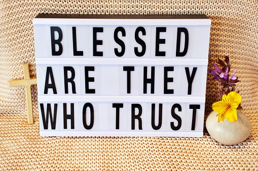 The words 'Blessed Are They Who Trust' in a modern light box theme surrounded by religious cross, crucifix, plants and flowers. This is part of my Signs of the Times collection inspired by church billboard signs for a religious revival movement and great awakening.