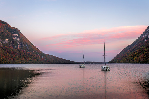 Autumn colors over Lake Willoughby and boats at dawn