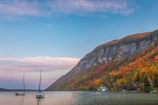 Autumn colors over Lake Willoughby and boats at dawn