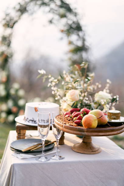 istock Fruit platter stands near glasses and wedding cake on the table 1778922882