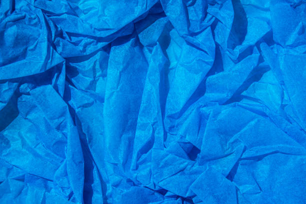 istock Crumpled blue paper background texture close up with copy space. Blue crumpled tissue paper for background. 1778924014