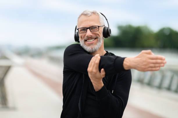 istock Happy elderly man stretching arms in park with music 1778925262