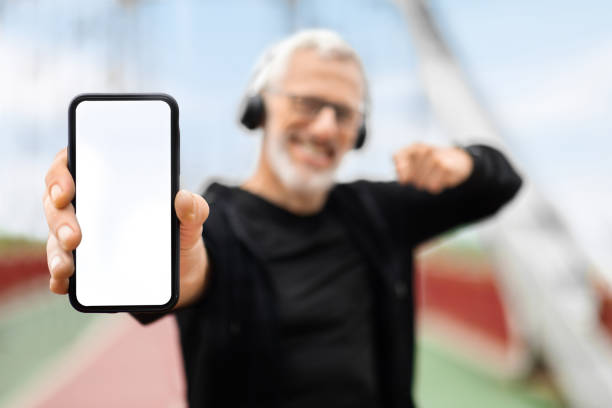 istock Phone with empty white screen in elderly sportsman hand 1778925825