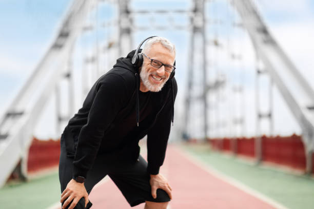istock Cheerful elderly man resting after jogging by footbridge 1778925865