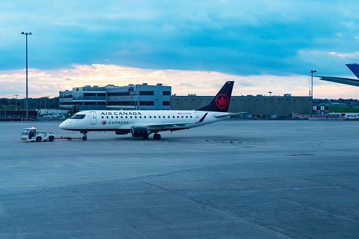 An Air Canada airplane parking at the runway of Toronto Pearson International Airport, Canada.