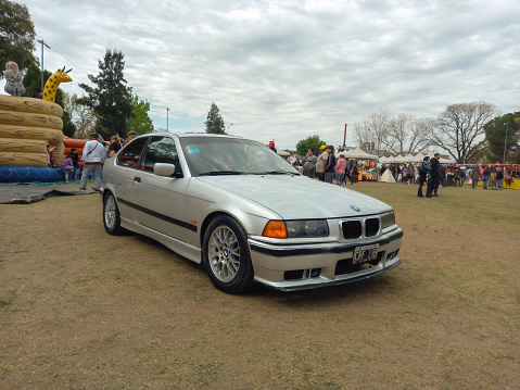 Lanús, Argentina - Sept 24, 2023: sporty German luxury 1990s BMW E36 3 Series 318 coupe hatchback in a park. Classic car show