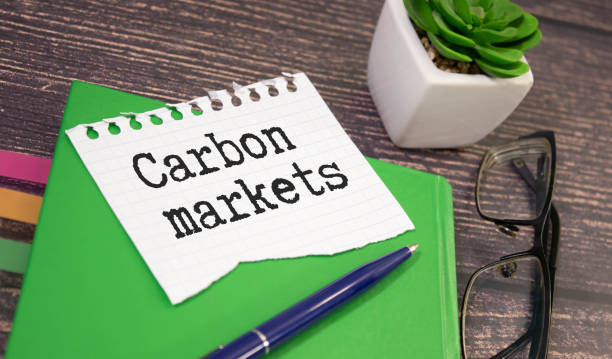 istock CARBON MARKETS. text on white paper near dollar bills. 1778990145