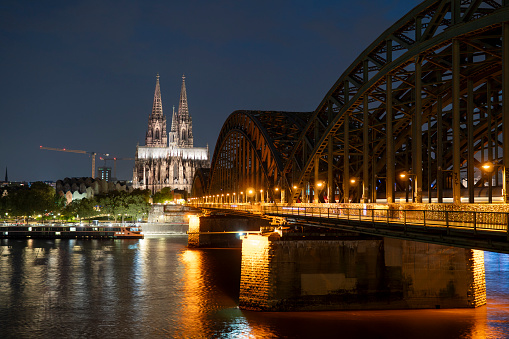 Cologne, Germany, September 11, 2023: Cologne Cathedral is a famous monument of German Catholicism and Gothic architecture and a symbol of Germany. Hohenzollern Bridge is one of the most important railway junctions in Europe