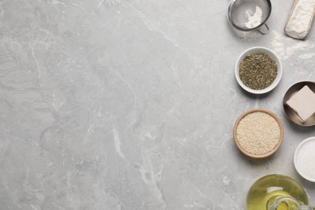 istock Cooking grissini. Different ingredients on grey marble table, flat lay. Space for text 1779049791