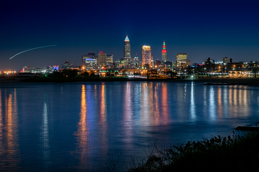City of Cleveland Lights Reflecting in the Water with Airplane Light Trail