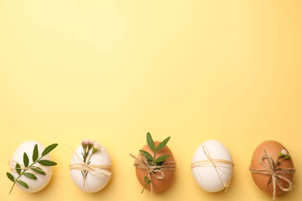 istock Festively decorated chicken eggs on yellow background, flat lay with space for text. Happy Easter 1779065817