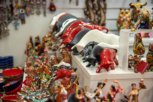 Valencia, Market, Spain ,2022, Multicolored mosaic figurine of bull in Gaudi style. Spanish traditional gifts in the souvenir shop. High quality photo