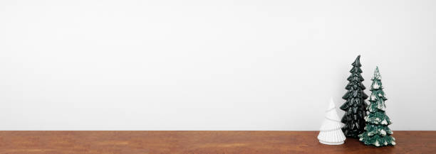 istock Christmas tree decor on a wood shelf against a white wall banner background 1779071823