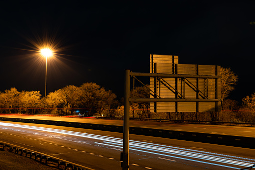 Long exposure shot of highway at night with car light trails.
