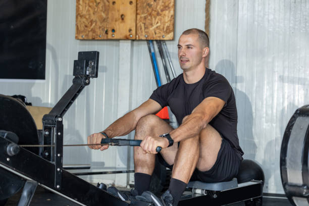 istock Fitness man on rowing machine doing exercises 1779105075