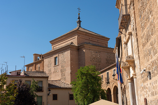 Roofs of a building with a Catholic cross on a street in the city of Toledo. Castilla la Mancha. Spain. July 29, 2023.