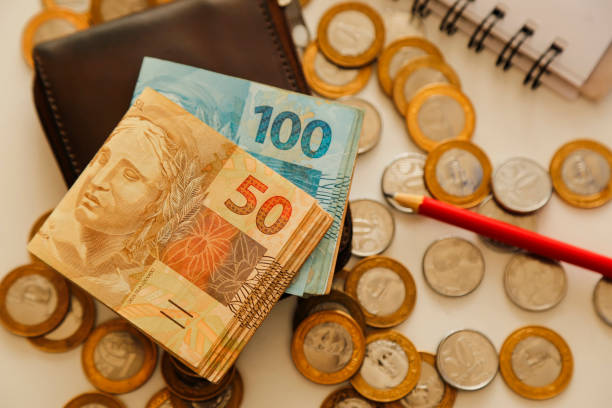 istock fifty real notes and other notes and coins on the table with wallet, pencil and notebook 1779161217