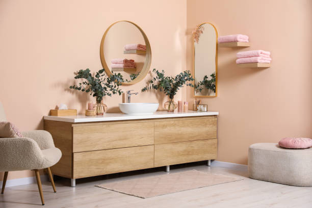 istock Modern bathroom interior with stylish mirror, eucalyptus branches, vessel sink and wooden vanity 1779178167