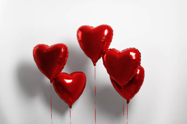 istock Many red heart shaped balloons on white background 1779181617