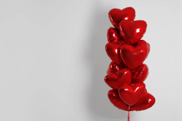 istock Many red heart shaped balloons on white background, space for text 1779181649