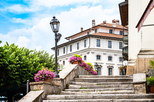 Italy : the stairs of the church of San Vittore, and the Borromeo palace in background, on Isola Bella, on lake Maggiore (Borromean Islands in Northern Italy, Great Lakes region). July 23, 2023