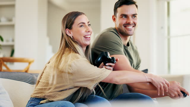 Gaming, play or happy couple with video game in arcade competition on website online at home. Smile, fun gamers or excited people streaming on digital technology to relax on house living room couch