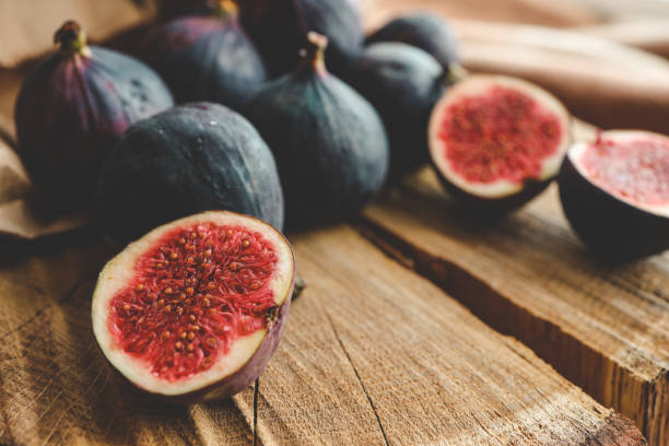 istock A few figs in a bowl on an old wooden background. 1779204959
