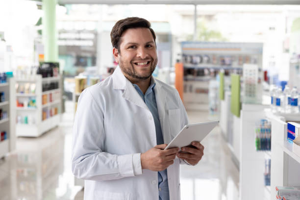 istock Happy pharmacist working at the drugstore using a digital tablet 1779207227
