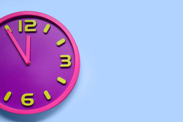 istock Clock showing five minutes until midnight on light blue background, top view with space for text. New Year countdown 1779208347