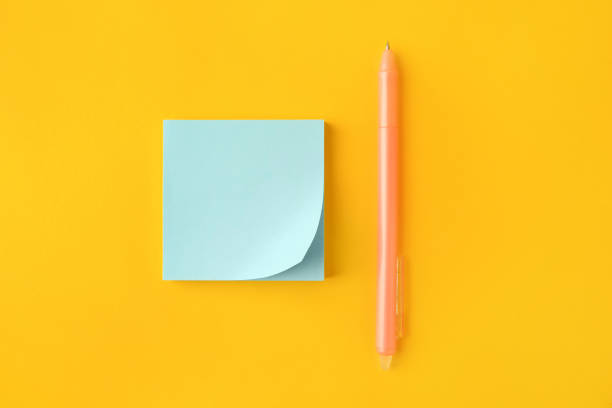 istock Blank paper note and pen on orange background, flat lay 1779208942