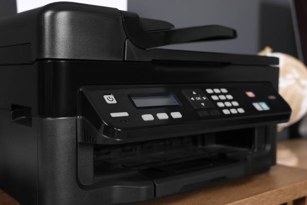 istock Modern printer on wooden desk at home, closeup 1779211711