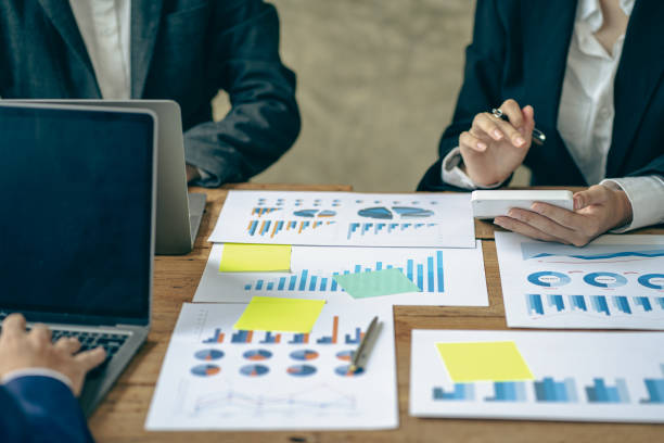 istock business team working They are analyzing financial reports and using calculators. accounting calculations And partners point to financial reports to analyze the company's sales plans. 1779225535