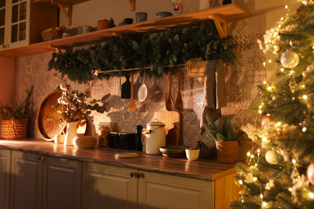 istock Stylish kitchen with festive decor and Christmas tree. Interior design 1779226711