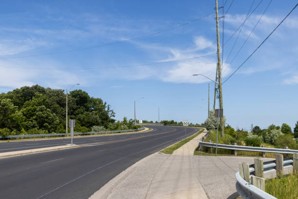 istock Empty highway - blue sky - green trees - power lines - guard rail 1779227268