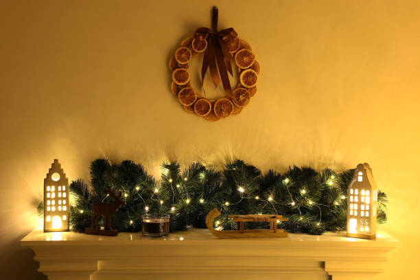 istock Fireplace with Christmas accessories and decorative wreath on white wall 1779228338
