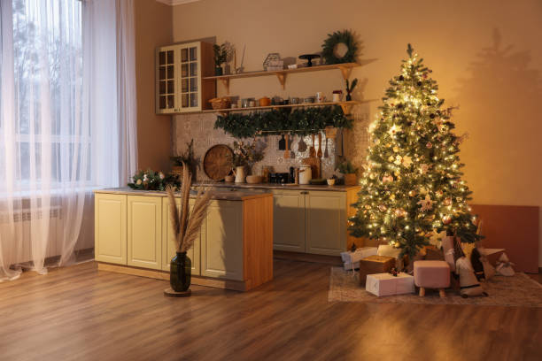 istock Stylish kitchen with festive decor and Christmas tree. Interior design 1779228883