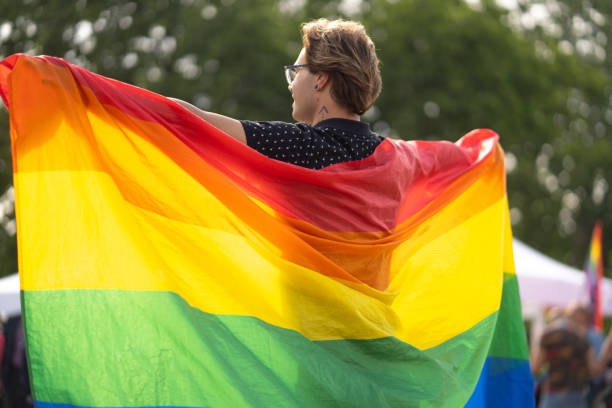 istock A gay man holding a large pride flag on a pride event 1779228907