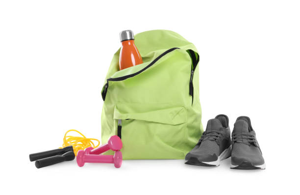 Backpack with sports equipment on white background