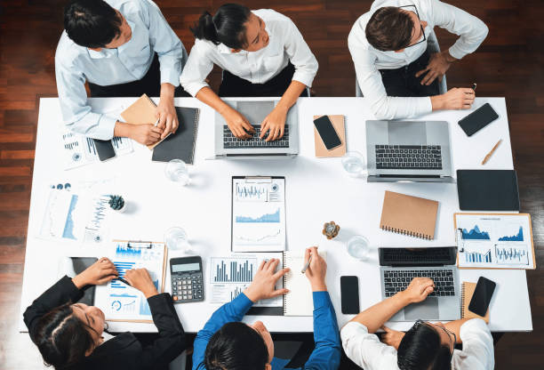 istock Analyst team utilizing BI Fintech to analyze financial data at table. Prudent 1779278431
