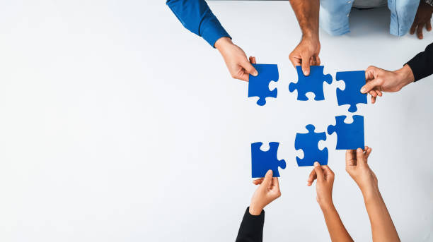 Business team joining jigsaw puzzle together. Prudent