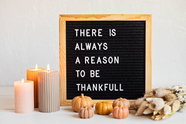 istock Felt letter board and text there is always a reason to be thankful. Autumn table decoration. Interior decor for thanksgiving and fall holidays with handmade pumpkins, candles 1779310131
