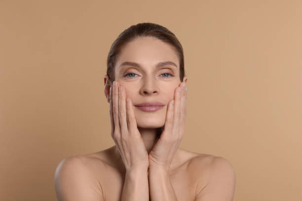 istock Woman massaging her face on beige background 1779331972
