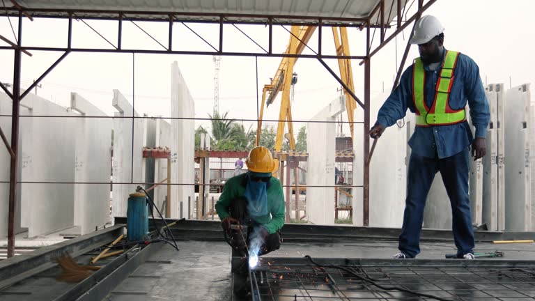 Engineer inspecting house construction at construction site.