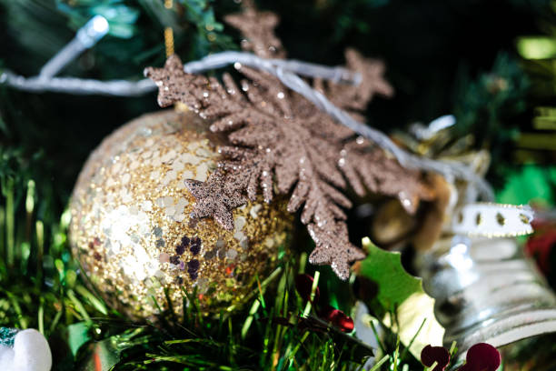istock Christmas tree branch decorated with golden and glitter ball 1779357995