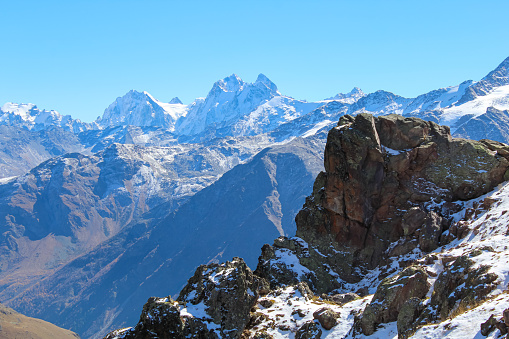 Dramatic landscape - the picturesque Baksan valley with a dark granite volcanic rocks against the blue sky in the Elbrus region in the North Caucasus