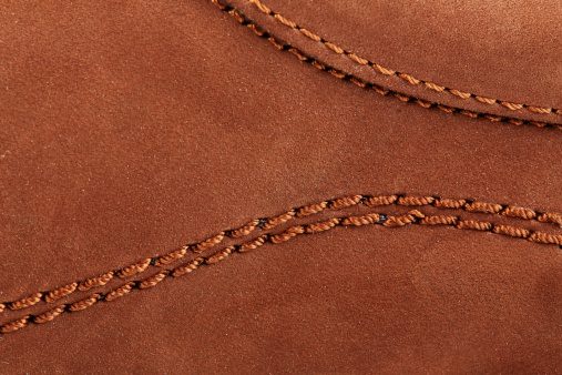 Suede surface of a boot with stitches