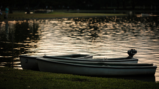 Boats parked at the lake during sunset