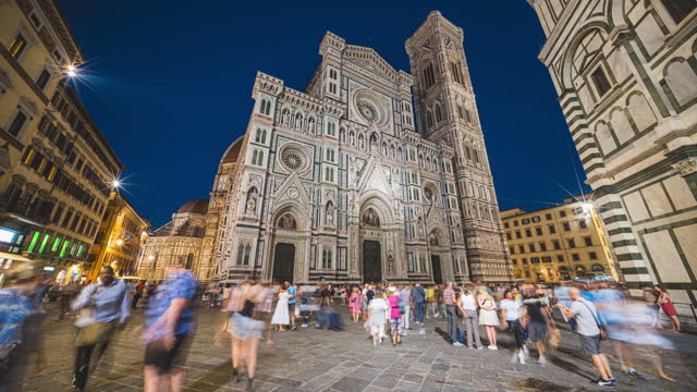 Time lapse of Crowd of People tourist walking and sightseeing attraction at Cathedral of Santa Maria del Fiore around Piazza del Duomo at night in Florence, Tuscany, Italy